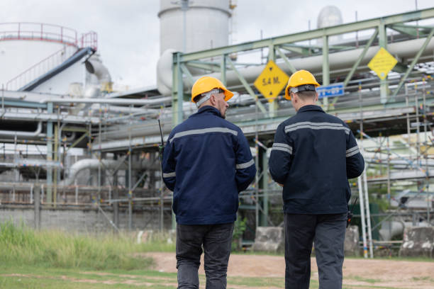 istock Back view of petroleum engineer  working at oil refinery site 2166485575