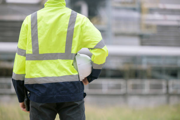 istock Back view of petroleum engineer hold hardhat with blank copyspace 2166485585