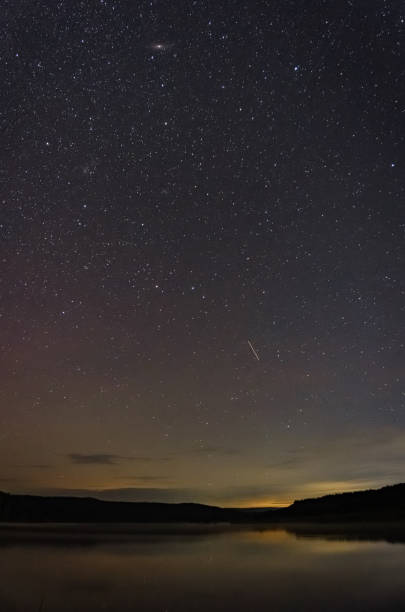 istock starry sky over the lake on a summer night 2166486410