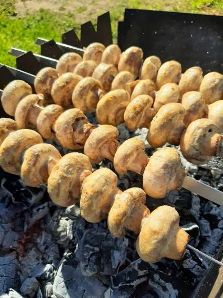 istock champignon mushrooms are fried on skewers over coals 2166487687