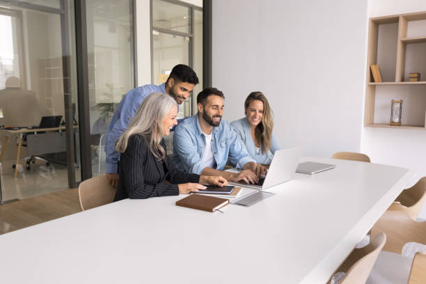 istock Multiethnic business team of positive colleagues watching Internet content 2166488813