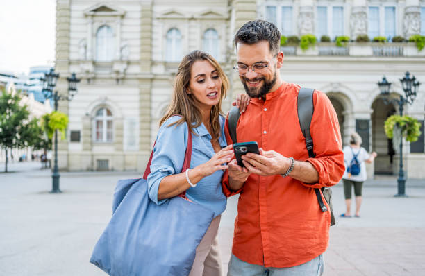 istock Couple looking at a mobile phone outdoors 2166489052
