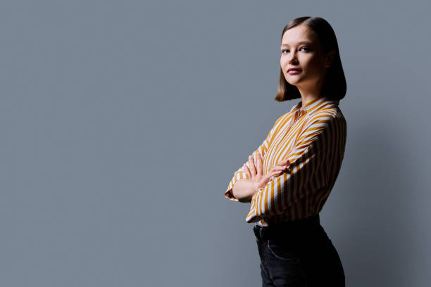 istock Profile view, confident young business woman, copy space gray studio background 2166489742