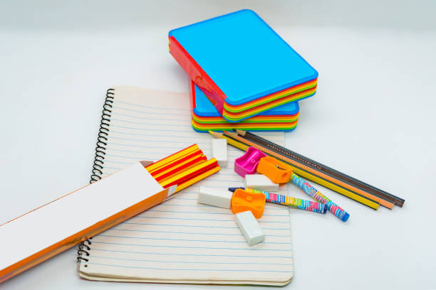 istock a stack of pencils, pens, and pencils are on a notebook with color book 2166490020
