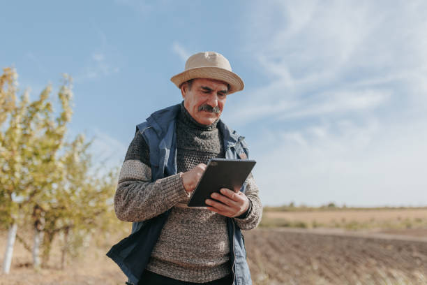 istock Technology Meets Tradition Senior Farmer Checking Harvest with Tablet 2166491444
