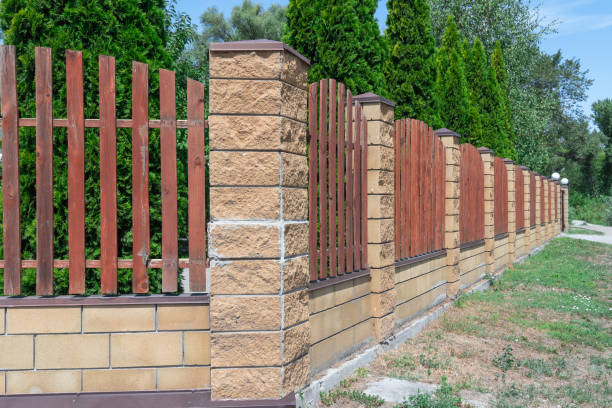 istock Fence with wooden panels and brick wall on yard grounds. 2166492149