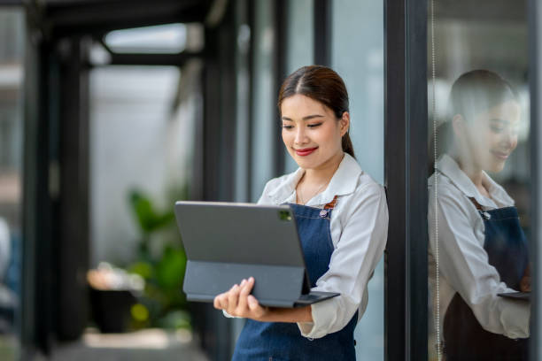 istock A woman is holding a laptop and smiling 2166493902