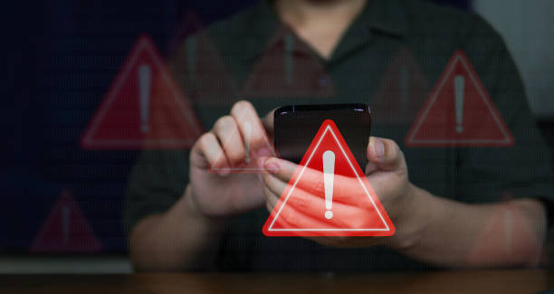 istock Emergency warning alert alarm on Smartphone, Data network protection, Virus alarm with people using application on smartphone. 2166494100