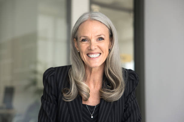 istock Happy senior executive lady in formal cloth looking at camera 2166495032