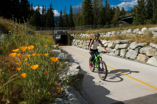 istock Woman bicycles on paved pathway 2166495220