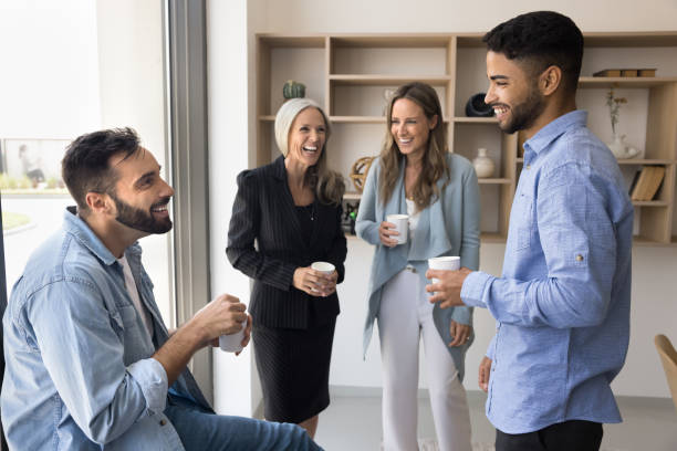 istock Cheerful diverse business colleagues talking and laughing 2166495477