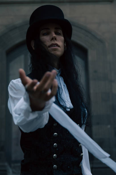 istock Mysterious gothic man wearing top hat reaching out hand 2166496034
