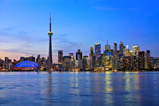 istock Toronto skyline at sunset with city lights reflected, Ontario, Canada 2166496973