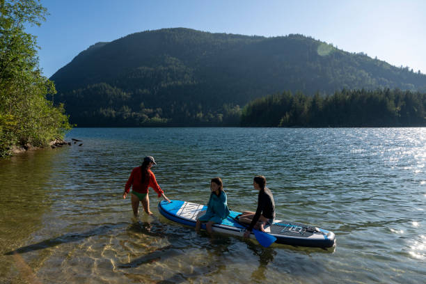 istock Mother and daughters SUP on lake 2166497764