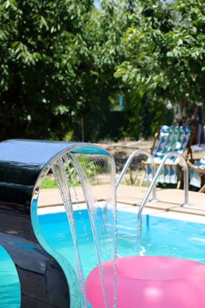 istock Pouring water in the swimming pool 2166500847