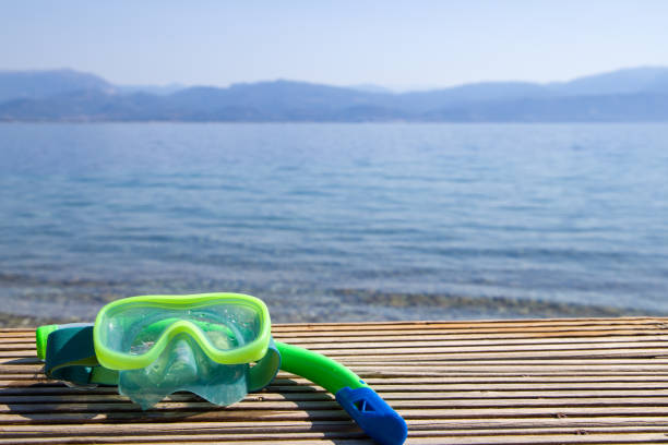 Snorkeling mask and snorkel on the beach. Copy space.