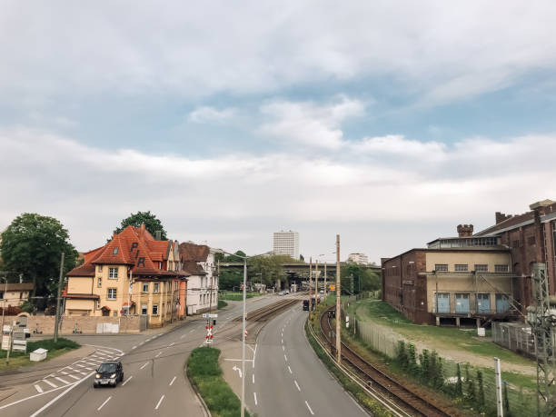 istock A city street with a train track running through it 2166503169