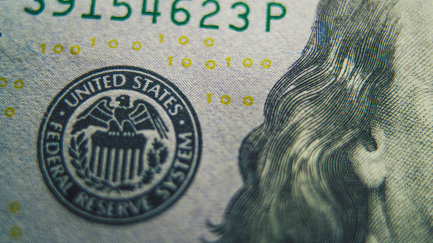 istock Process of examining authenticity of of hundred dollar bill 2166510178
