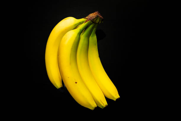 istock Bunch of bananas isolated on Black background 2166512345