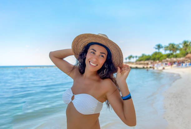Caribbean bliss: White bikini-clad woman embraces life on a tropical beach