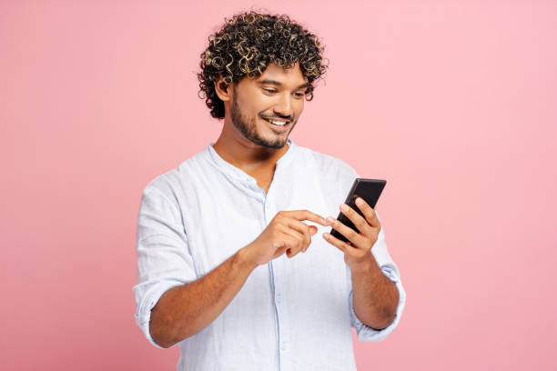 istock Young man browsing social media on smartphone, enjoying online communication 2166513369