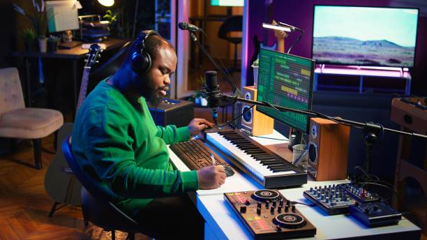istock Talented famous composer writes down new verses and lyrics in home studio 2166513583
