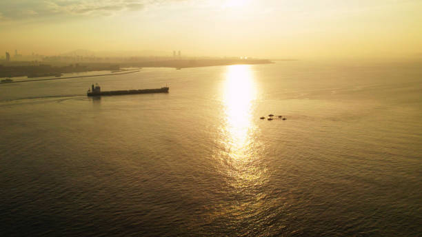 Sun rises above sea, Aerial view of cargo ship, Bosphorus Strait