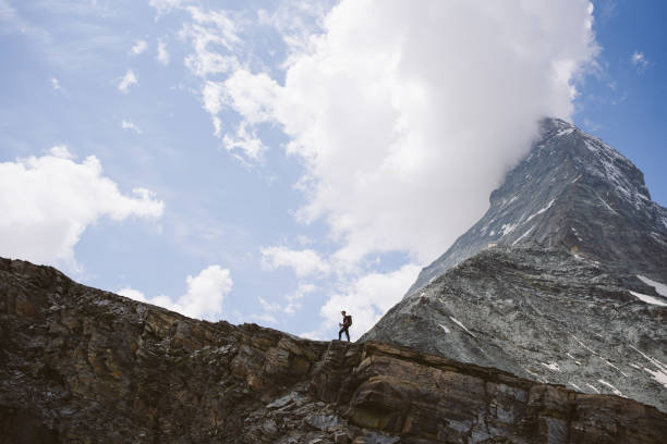 Hiker in foreground. Matterhorn near Zermatt, Valais