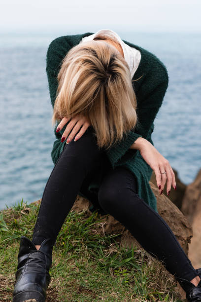 In an abandoned house near by sea and mountain Generation Z non-binary person exhibiting mental problems. transgender, 20-29 years old, self healing