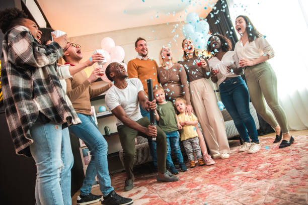 istock Diverse Group Celebrates Gender Reveal Party with Blue Confetti 2166524989