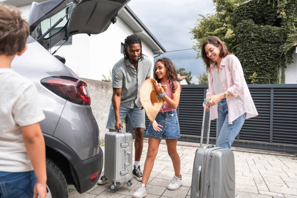 istock Diverse Family Prepares for Vacation with Car Packing 2166530685