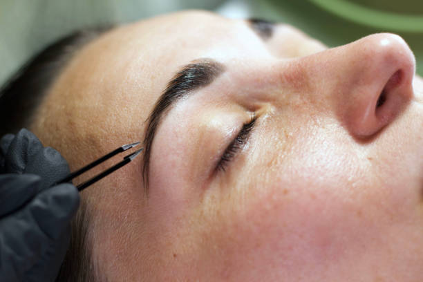 istock Precise Eyebrow Tweezing During Beauty Treatment 2166534339