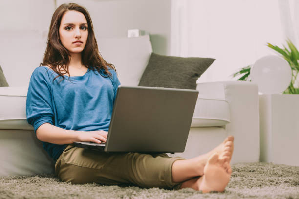 istock Thoughtful woman considers survival, laptop on lap 2166538121