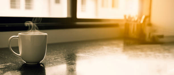 istock Minimalist White Ceramic Coffee Cup: Empty and Clean, Resting on a Table with Morning Light Reflecting Through a Window. 2166538414