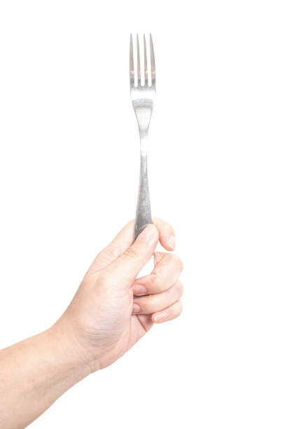 istock Female hand holding a silver steel fork isolated on white background. 2166538457