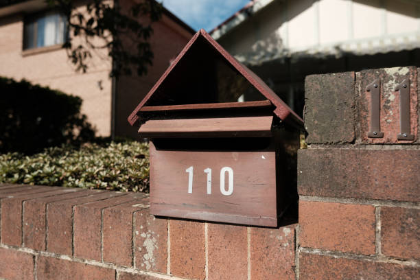 istock Brown wooden mailbox on a brick wall 2166538778