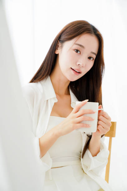 istock Young woman relaxing with a mug 2166540665
