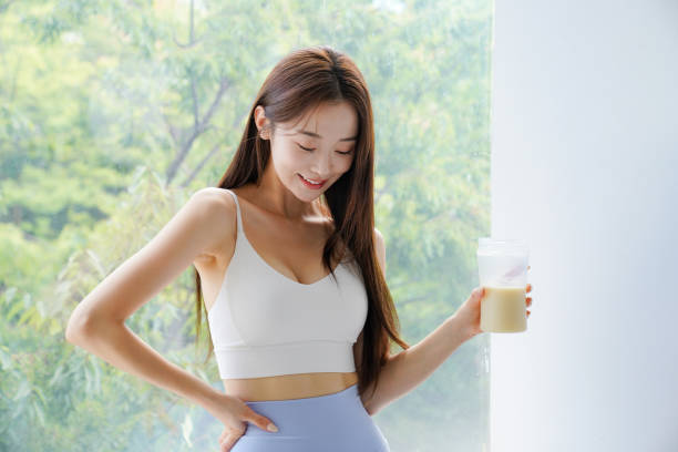 Young Asian woman drinking a protein drink