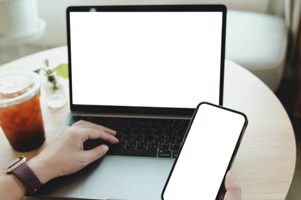 istock A blank screen for hand typing text,using laptop and mobile phone contact business searching information in workplace on desk at office. 2166542664