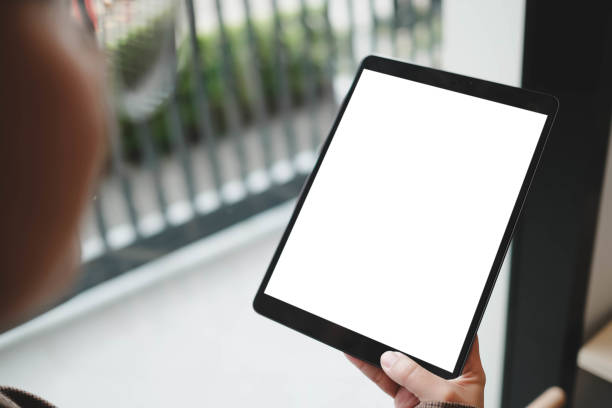 istock Mockup image of woman's hand holding black tablet pc with blank white screen at office. 2166542683