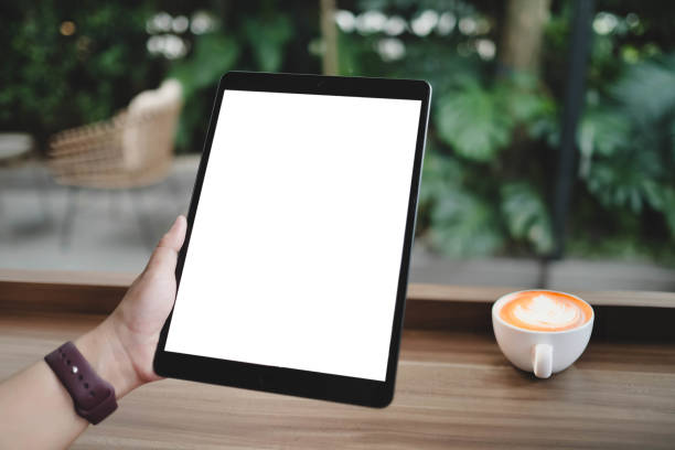 istock Mockup image of woman's hand holding black tablet pc with blank white screen at office. 2166543208