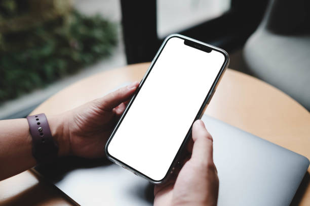 istock Close up view of a man using blank screen smartphone in cafe. 2166543211