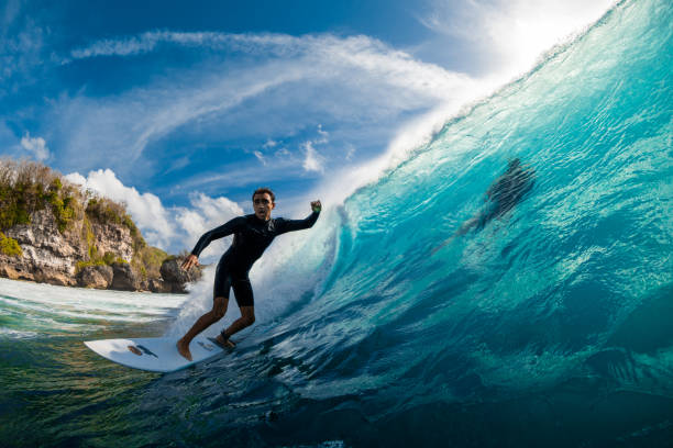 Surfer ride on surfboard at barrel wave. Professional surfing in ocean August 08, 2024. Bali, Indonesia. Surfer ride on surfboard at barrel wave. Professional surfing in ocean man wearing a barrel stock pictures, royalty-free photos & images