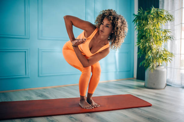 istock Young woman taking exercise in her living room. 2166549259