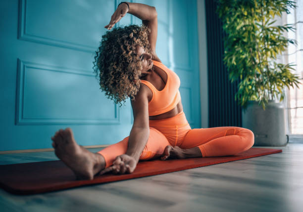 istock Young woman taking exercise in her living room. 2166549538