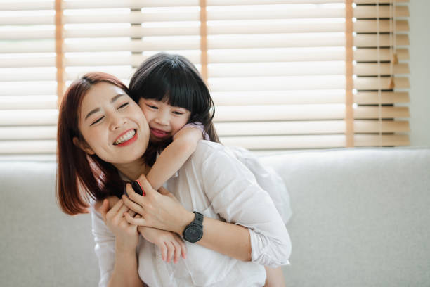 istock A woman is holding a small child on her back 2166550603