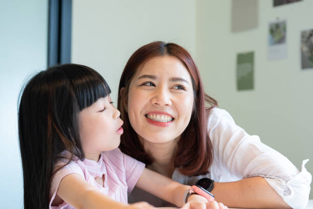 istock A woman is hugging a young girl 2166550609