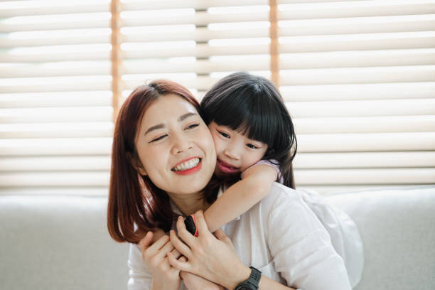 istock A woman is hugging a young girl 2166550621