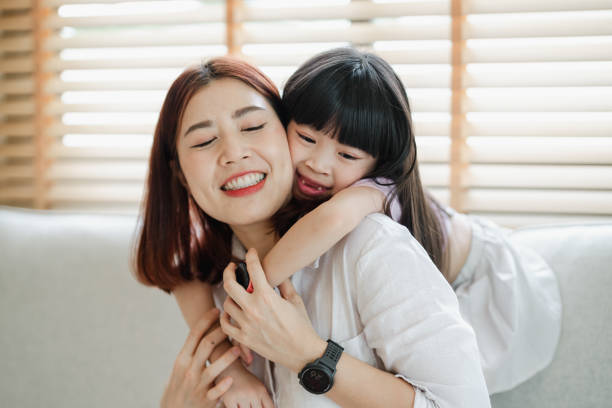 istock A woman is hugging a young girl 2166550629