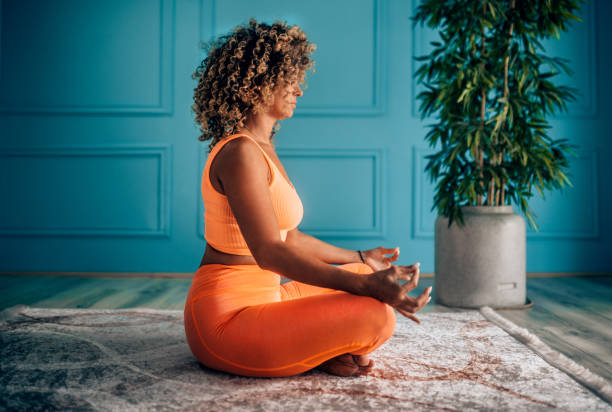 istock Young Woman Practicing Breathing Exercise At Home 2166552124
